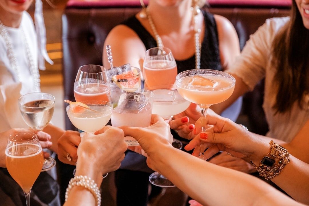 Gäster skålar med färgglada drinkar under en festlig mingelkväll
